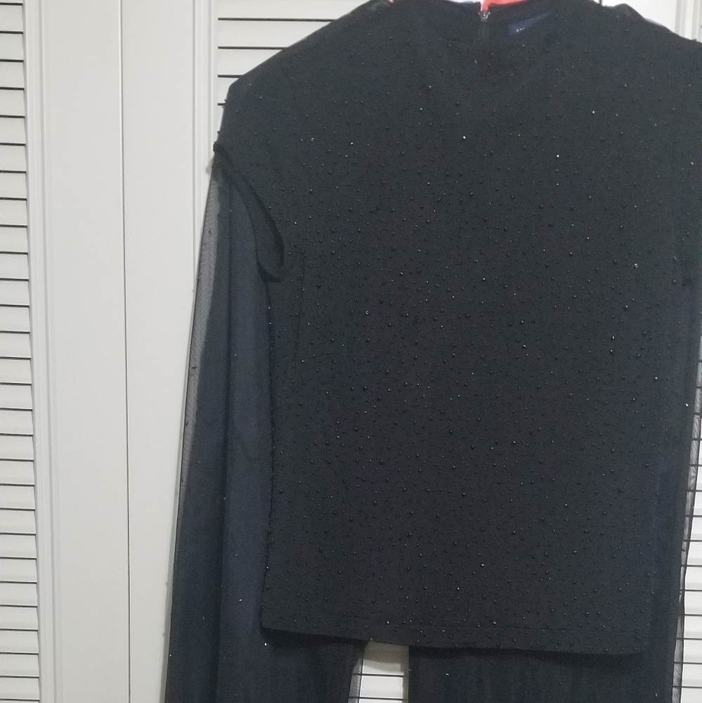 Beaded black top with black lined pants also beade
